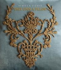 Book cover of Once Upon a Pillow, with a embroidered, gold crest on cushion. Published by Pointed Leaf Press.
