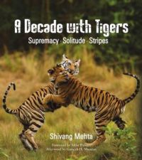 Book cover of A Decade with Tigers: Supremacy. Solitude. Stripes, with two tigers play fighting. Published by Niyogi Books.