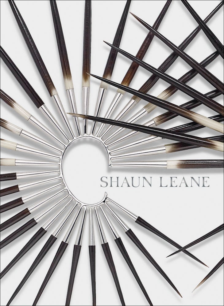 Large metal and wood spike ear cuff, on white cover of 'Shaun Leane', by ACC Art Books.