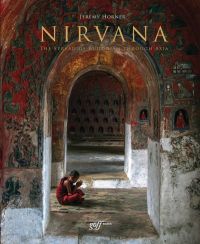 Child Buddhist monk seated on floor of temple, praying, on cover of 'Nirvana, The Spread of Buddhism Through Asia', by ORO Editions.