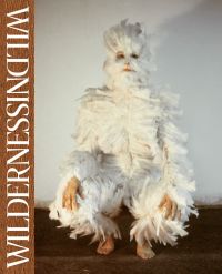 Ana Mendieta, 'Feathers on Woman' 1972, woman covered in white feathers crouching down, WILDNISS WILDERNESS in white font to left brown border.