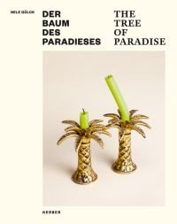 2 gold palm tree shaped candlestick holders, green candles on top, cream cover, NELE GÜLCK DER BAUM DES PARADIESES THE TREE OF PARADISE in black font above.