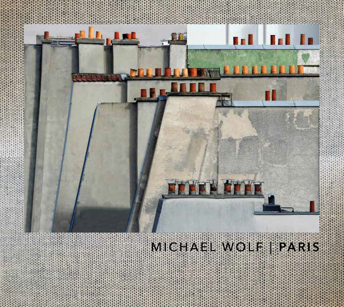Rooftops with small chimney pots in rows on top, on woven cover, MICHAEL WOLF PARIS in black font to lower right.