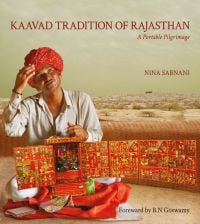 Book cover of Kaavad Tradition Of Rajasthan: A Portable Pilgrimage, with an Indian man holding a highly decorative portable shrine. Published by Niyogi Books.