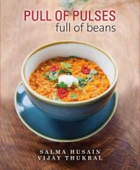 Book cover of Pull of Pulses: Full of Beans, with a bowl of daal curry. Published by Niyogi Books.