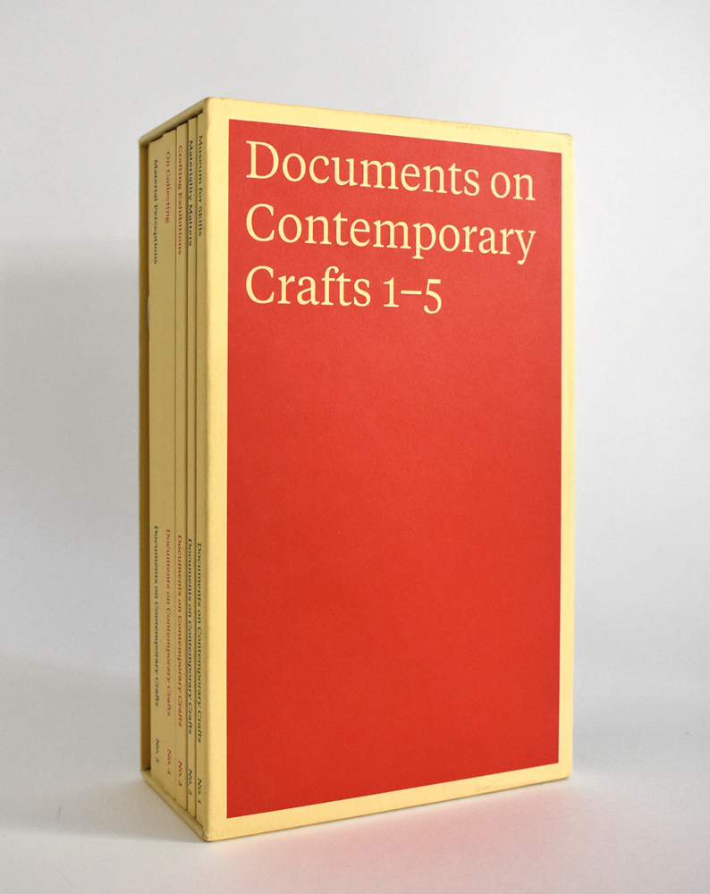 Boxset of 5 volumes in orange and cream, Documents on Contemporary Crafts 1-5 in cream font to top.