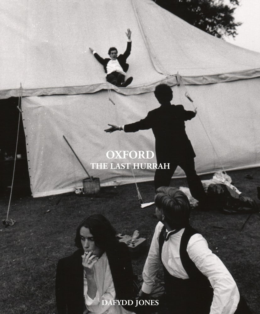 Book cover of 'Oxford The Last Hurrah, with a photo titled 'Sliding Down The Marquee, New College Ball, 1983' by Dafyyd Jones. Published by ACC Art Books.