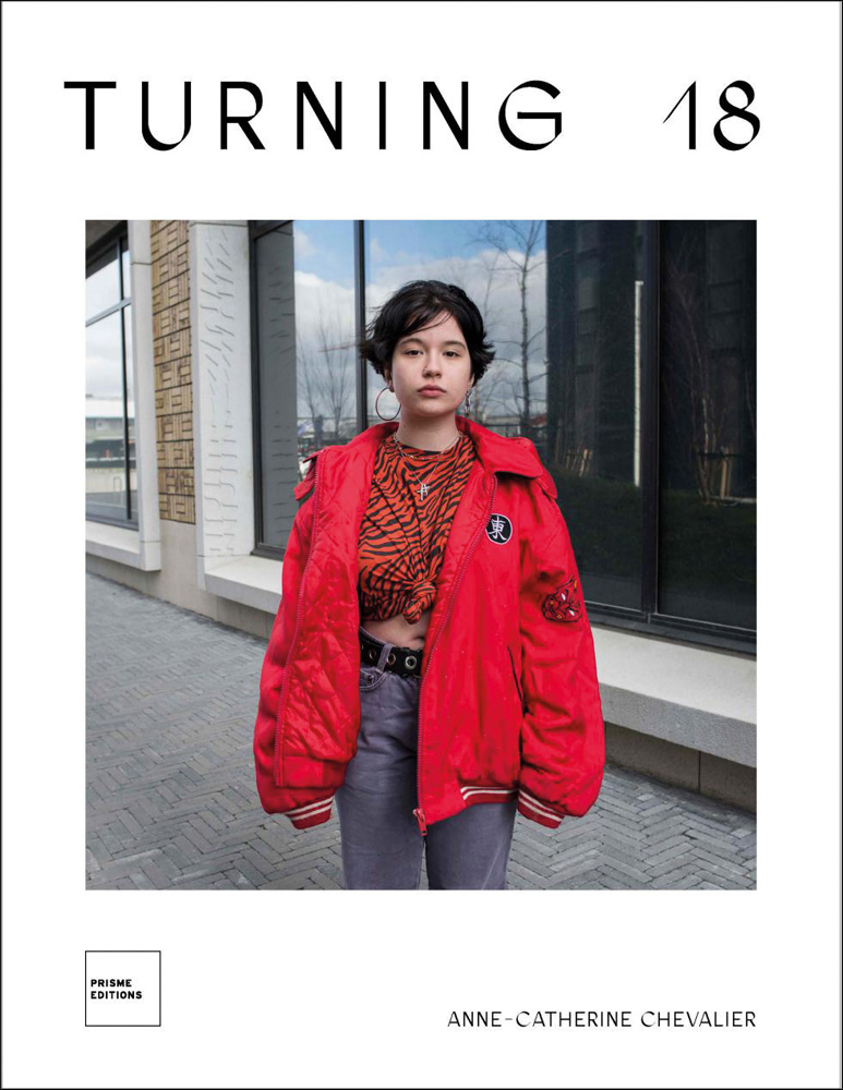 Portrait of female standing on street wearing red coat, tiger print t shirt and jeans, white cover, Turning 18 in black font above.