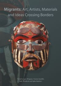 Book cover of Migrants: Art, Artists, Materials and Ideas Crossing Borders, with a decorative wood mask. Published by Archetype Publications.