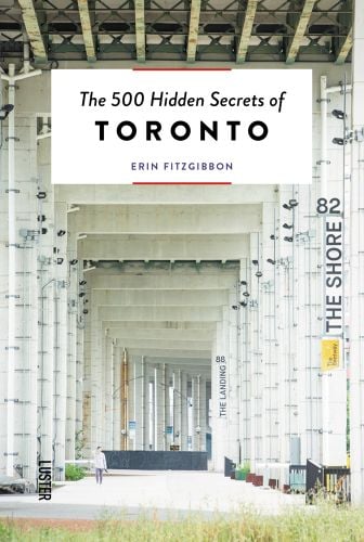 Large building structure with underpass, The 500 Hidden Secrets of TORONTO in black font on white banner above.