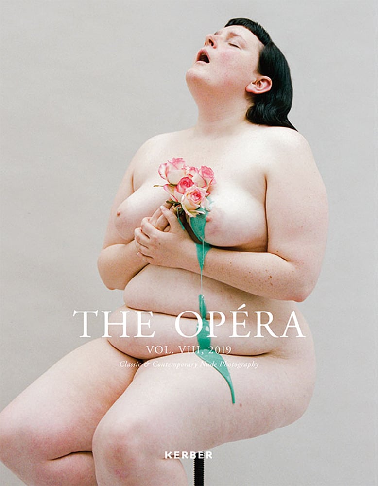 Nude white skinned female sitting on stool, head back, mouth open, holding bouquet of pink roses, The Opéra in white font