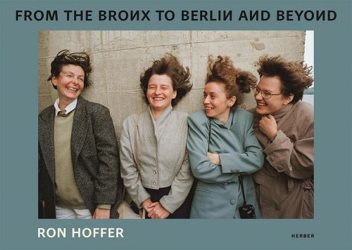 4 smiling females leaning on wall, hair blowing in wind, on blue cover, FROM THE BRONX TO BERLIN AND BEYOND Ron Hoffer in black and white font