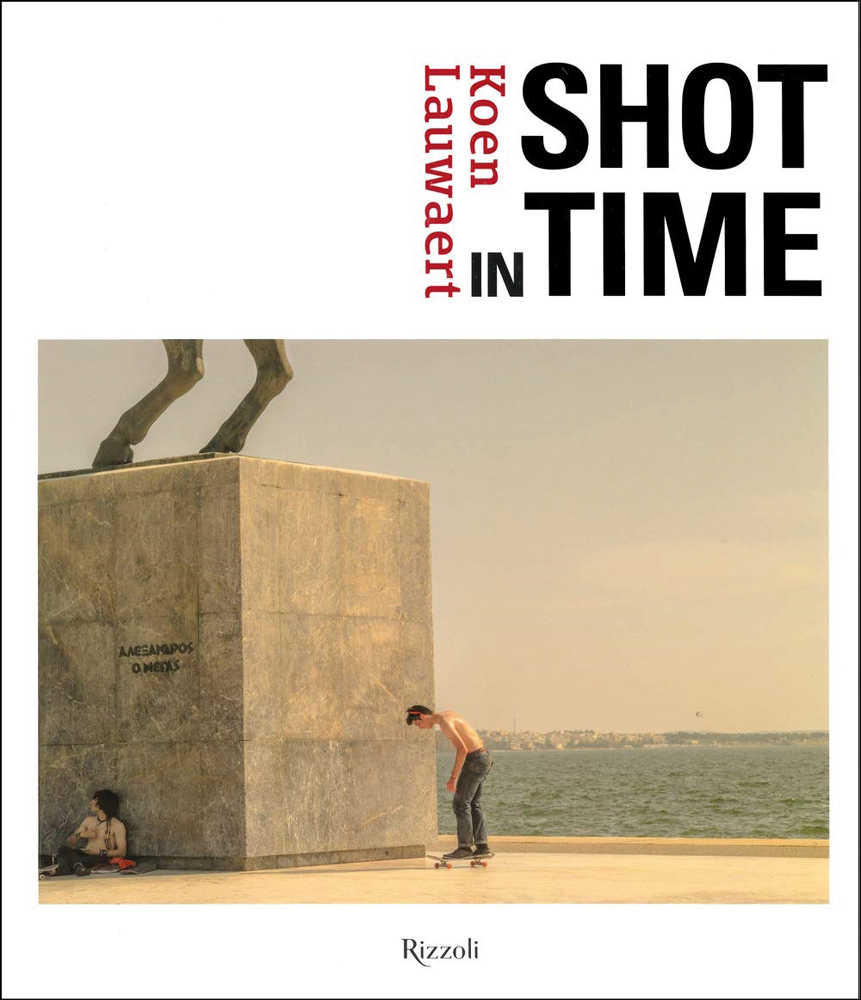 Skateboarder skating near large obscured sculpture on plinth, next to the sea, white cover, Koen Lauwaert SHOT TIME in red and black font above.