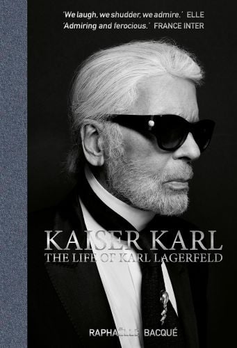 Black and white head and shoulders studio photograph of Karl Lagerfeld in dark glasses with Kaiser Karl the life of Karl Lagerfeld in white and grey