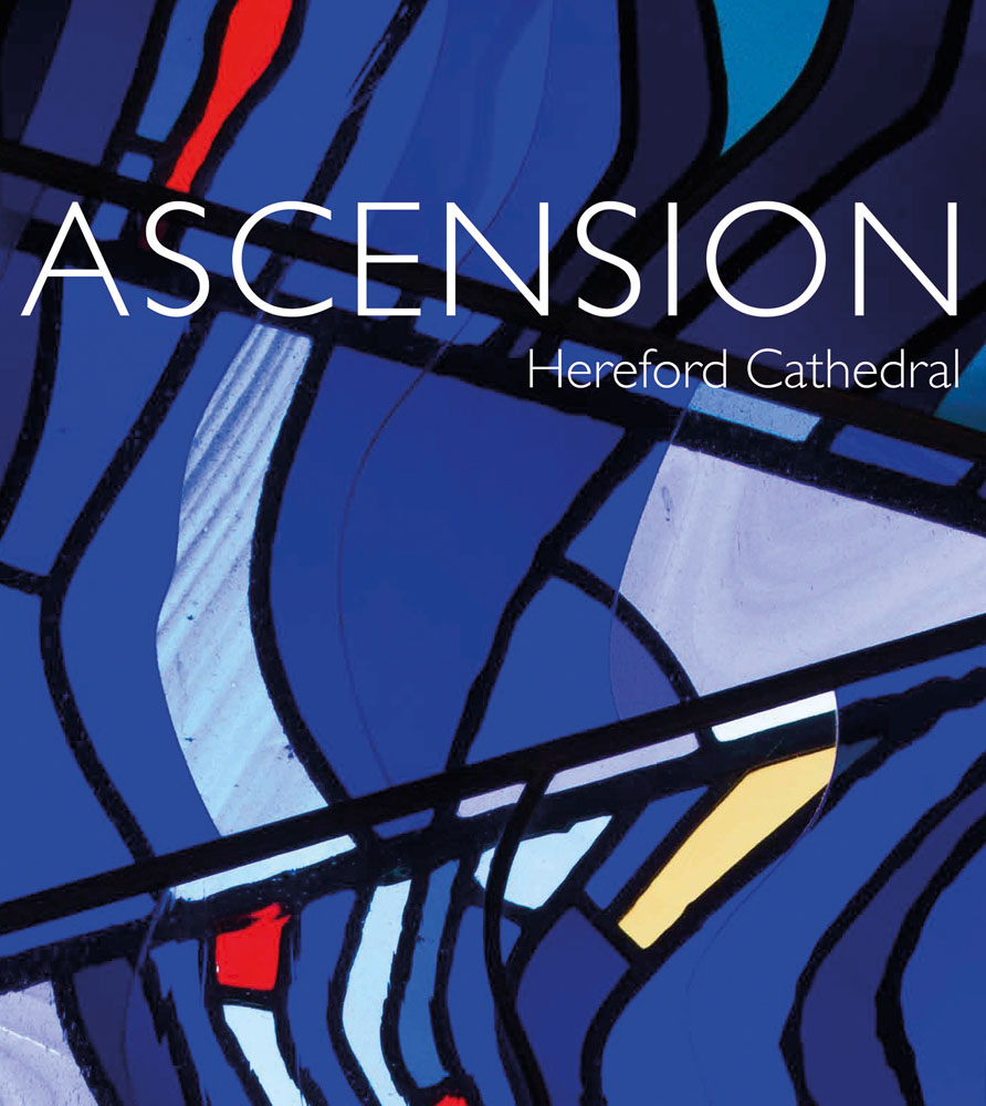 Close up of stained glass memorial window in blue tones, ASCENSION Hereford Cathedral in white font to upper portion.