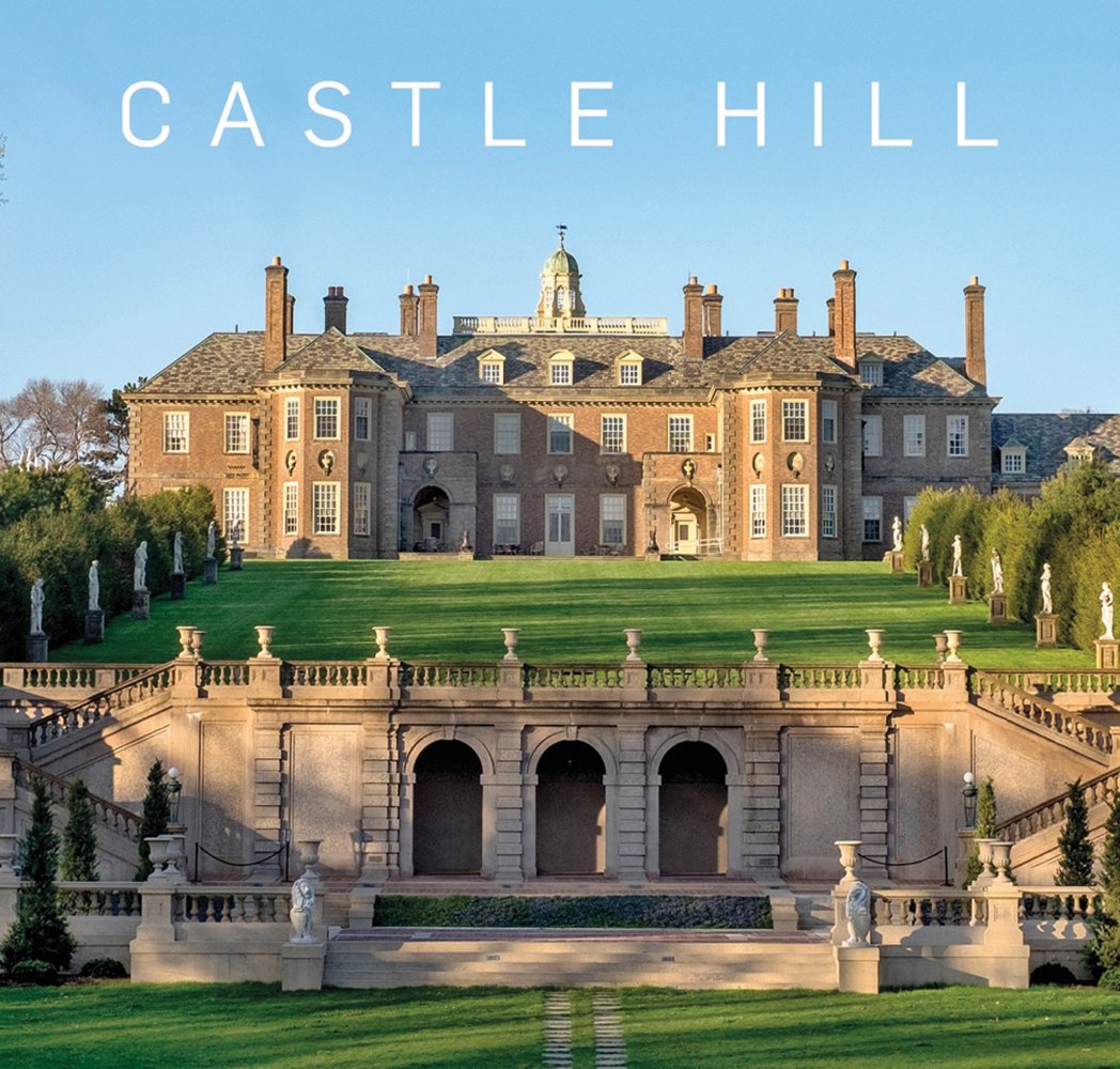 Tudor revival mansion Castle Hill under bright blue sky with maintained green grounds and Castle Hill in white font above