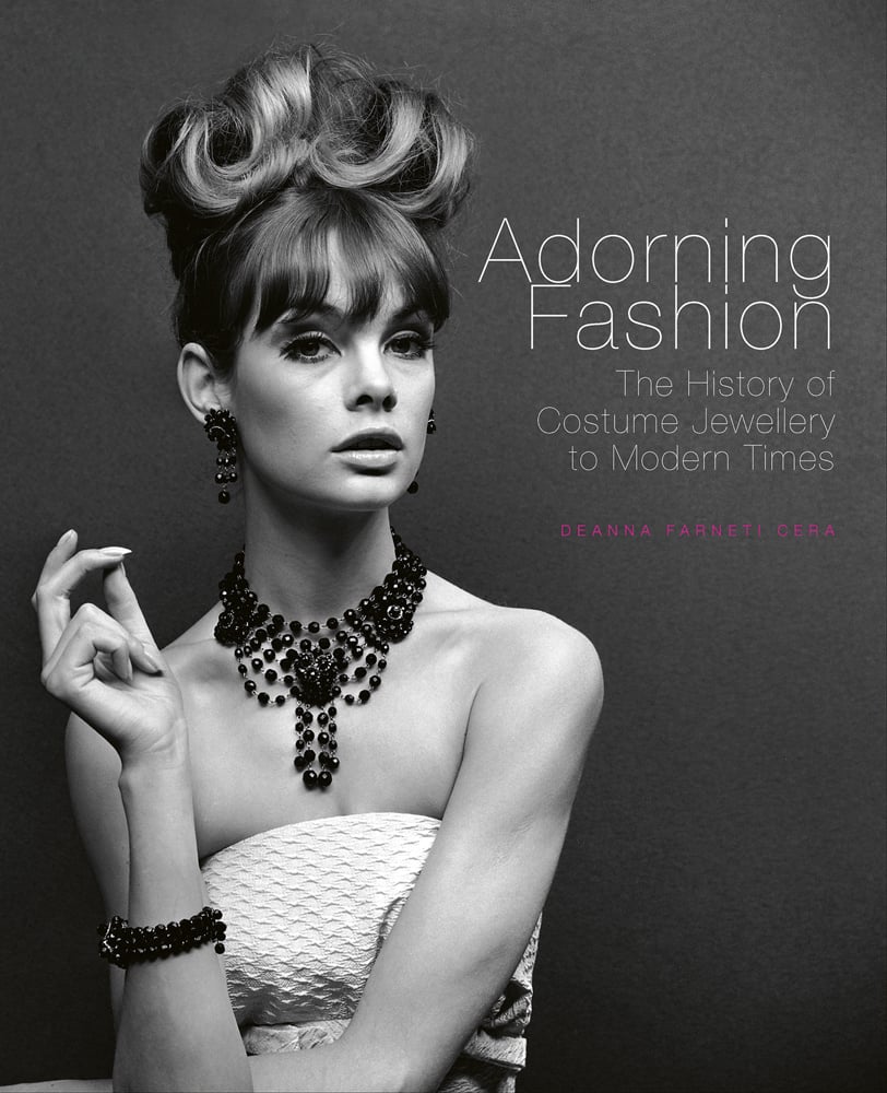 Book cover of Adorning Fashion: The History of Costume Jewellery to Modern Times, featuring Jean Shrimpton modelling large beaded jewellery for ‘Voice & Vision’, John French, 1963. Published by ACC Art Books.