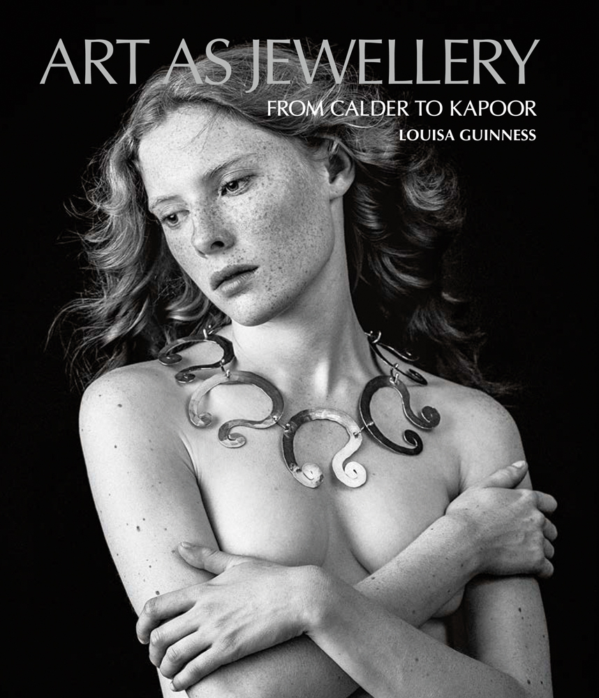 Topless model covering chest with arms, wearing large swirly metal necklace, on black cover of 'Art as Jewellery', by ACC Art Books.