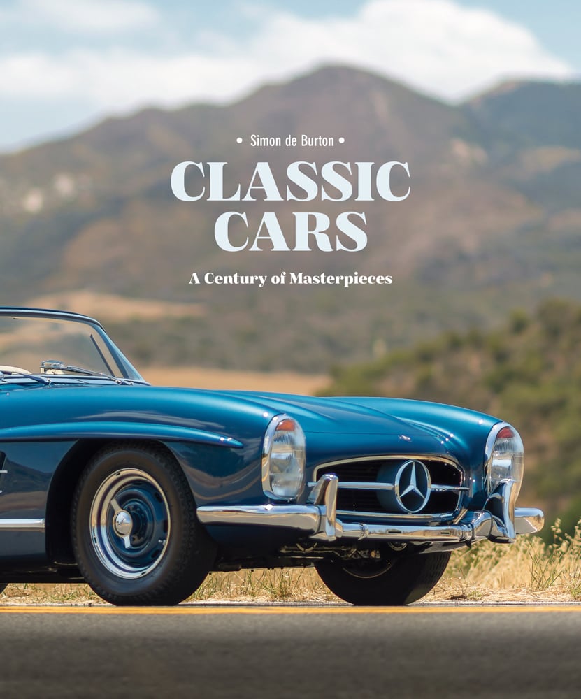 Colour photo of front end of blue Mercedes cabriolet classic car parked in front of a blurred mountain landscape with Classic Cars A Century of Masterpieces in white font above