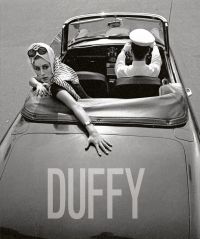 Fashion model in the back seat of convertible car driven by chauffer, on cover of 'Duffy', by ACC Art Books.