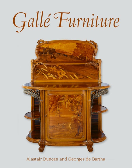 Sideboard in walnut, oak, and various woods, decorations of ears of wheat in patinated bronze, on cover of 'Gallé Furniture', by ACC Art Books.