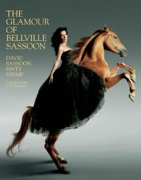 Nancy Dell'olio wearing long black bandeau dress while sitting on tan rearing horse, on cover of 'The Glamour of Bellville Sassoon', by ACC Art Books.