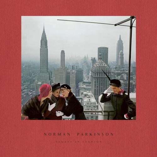 Dark pink cover with an iconic photo from 1949 of four fashion models with the New York skyline in the background with Norman Parkinson Always in Fashion in grey font below