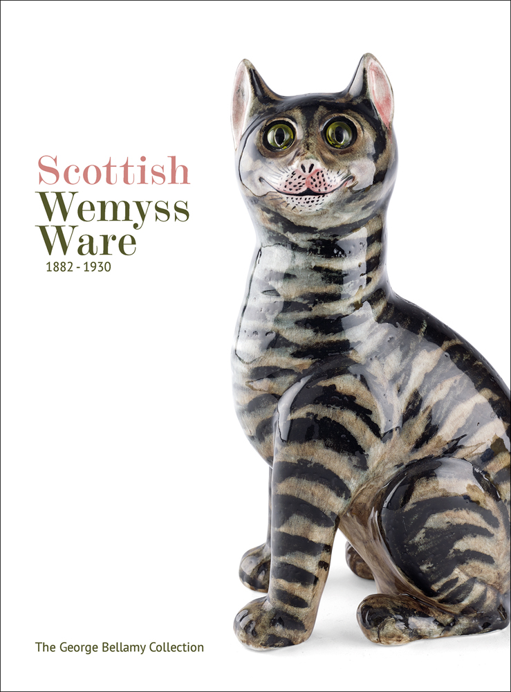 Wemyss Ware grinning cat with green eyes, on white cover of 'Scottish Wemyss Ware 1882-1930', by ACC Art Books.
