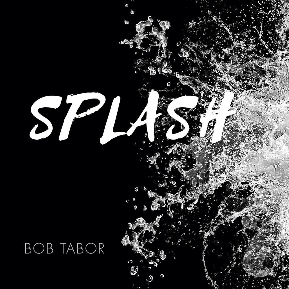Crisp, clear ocean splash of water on black cover of 'Splash', by ACC Art Books.