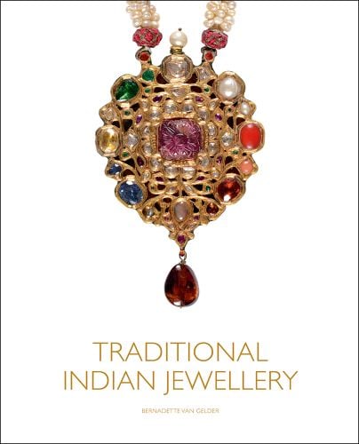 Photograph of a traditional Indian gold necklace decorated with gems and beads hanging on a white background with gold font title Traditional Indian Jewellery underneath