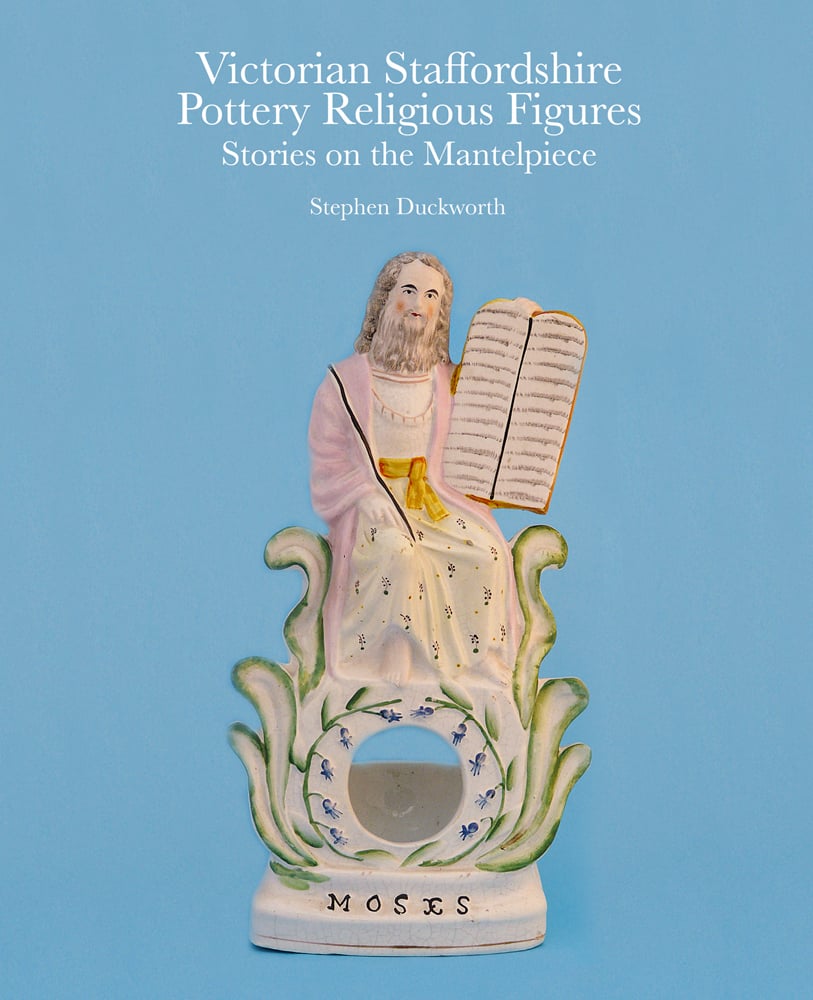 Biblical figurine of 'Moses', on blue cover of 'Victorian Staffordshire Pottery Religious Figures', by ACC Art Books.