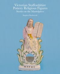Biblical figurine of 'Moses', on blue cover of 'Victorian Staffordshire Pottery Religious Figures', by ACC Art Books.