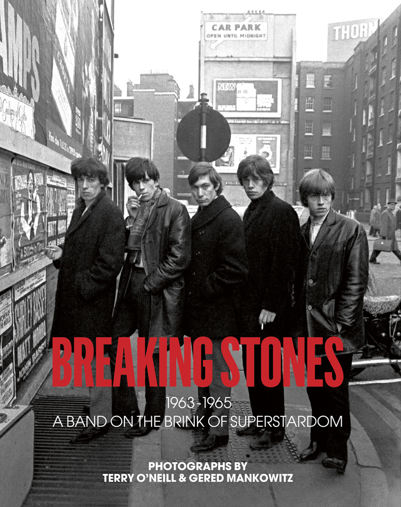 The Rolling Stones with Brian Jones, standing on city street, on cover of 'Breaking Stones', by ACC Art Books.