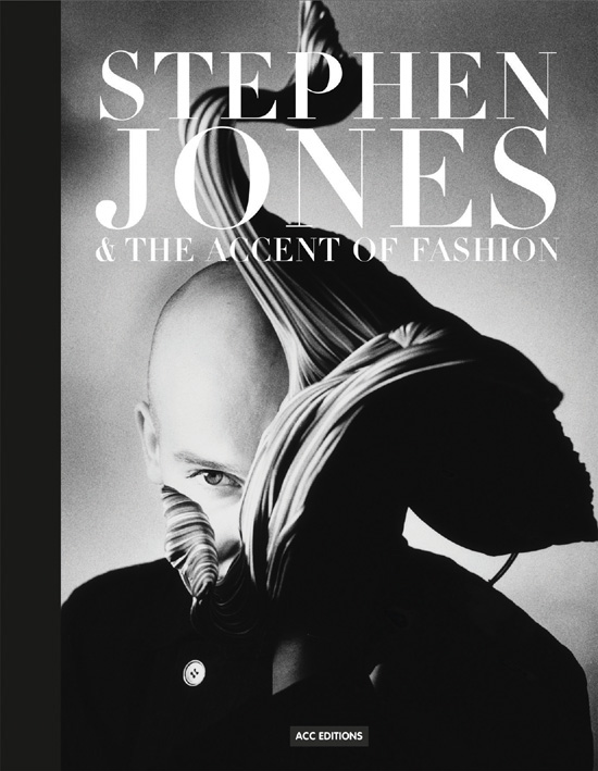 British milliner Stephen Jones wearing flamboyant, ruched hat to side of head, on cover of 'Stephen Jones, And the Accent of Fashion', by ACC Art Books.