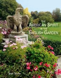 English landscaped garden with mature trees, pink flowers, stone eagle sculpture, on cover of 'American Spirit in the English Garden', by ACC Art Books.