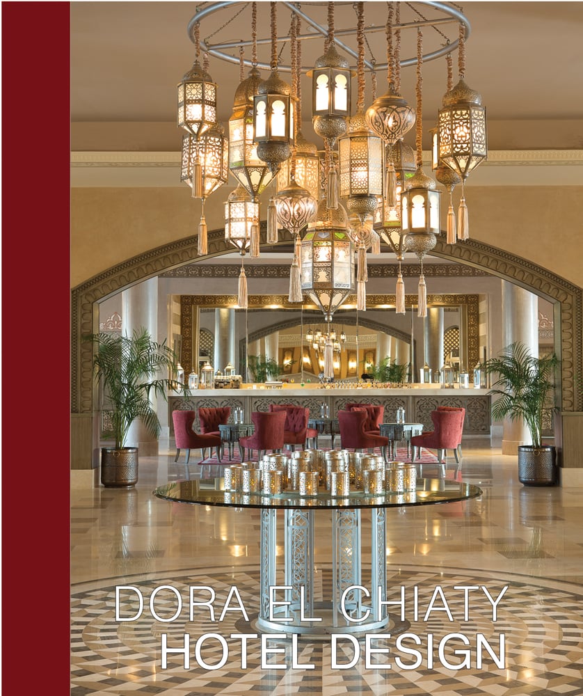 Luxury hotel interior lobby with gold decorative pendent chandelier, on cover of 'Dora el Chiaty, Hotel Design', by ACR Edition.