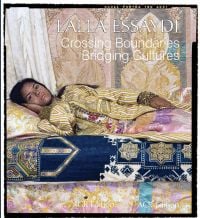 Chromogenic print 'Harem Revisited', dark-skinned girl wearing striped dress, lying on bed, on cover of 'Lalla Essaydi, Crossing Boundaries, Bridging Cultures', by ACR Edition.
