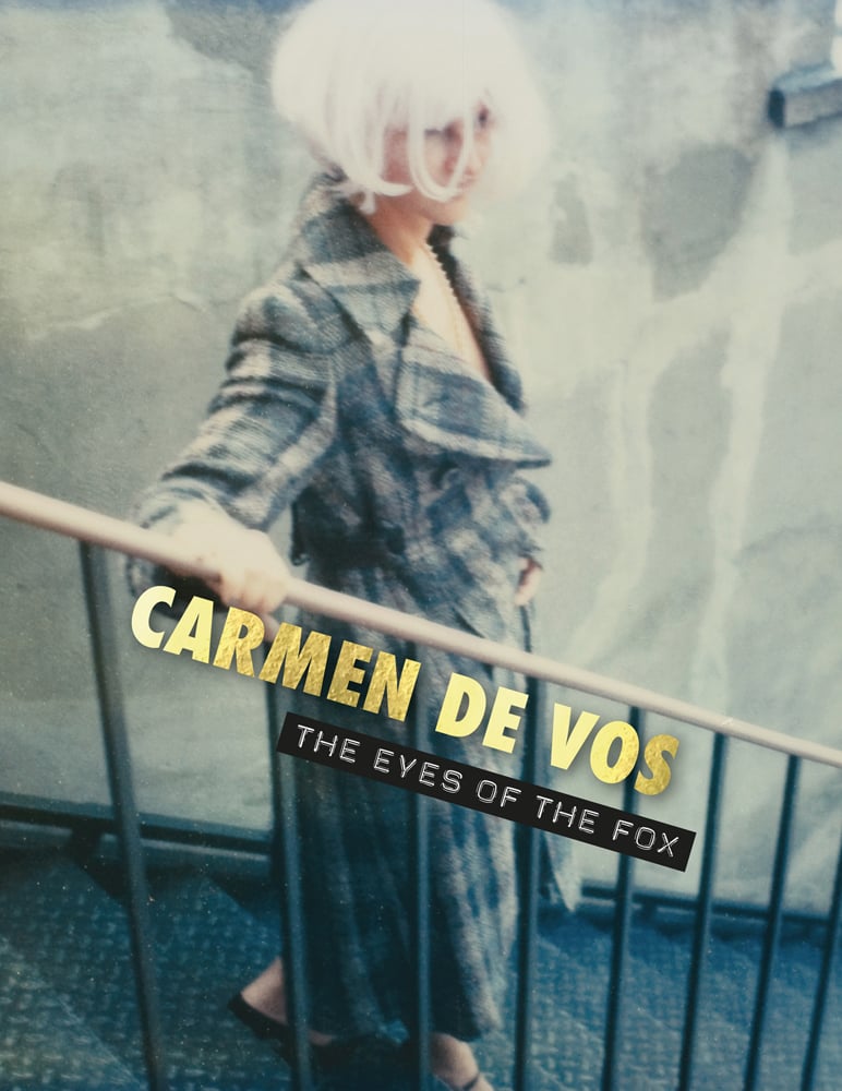 Book cover of Carmen de Vos: The Eyes of the Fox, featuring a women in long tartan dress and cropped blonde wig, walking down stairs holding bannister. Published by Exhibitions International.