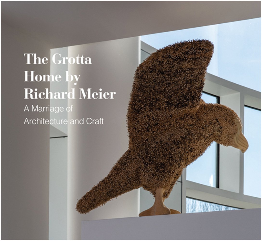Sculpture of bird made from wood and fibres, on white windowsill looking out, The Grotta Home by Richard Meier in white font to upper left.