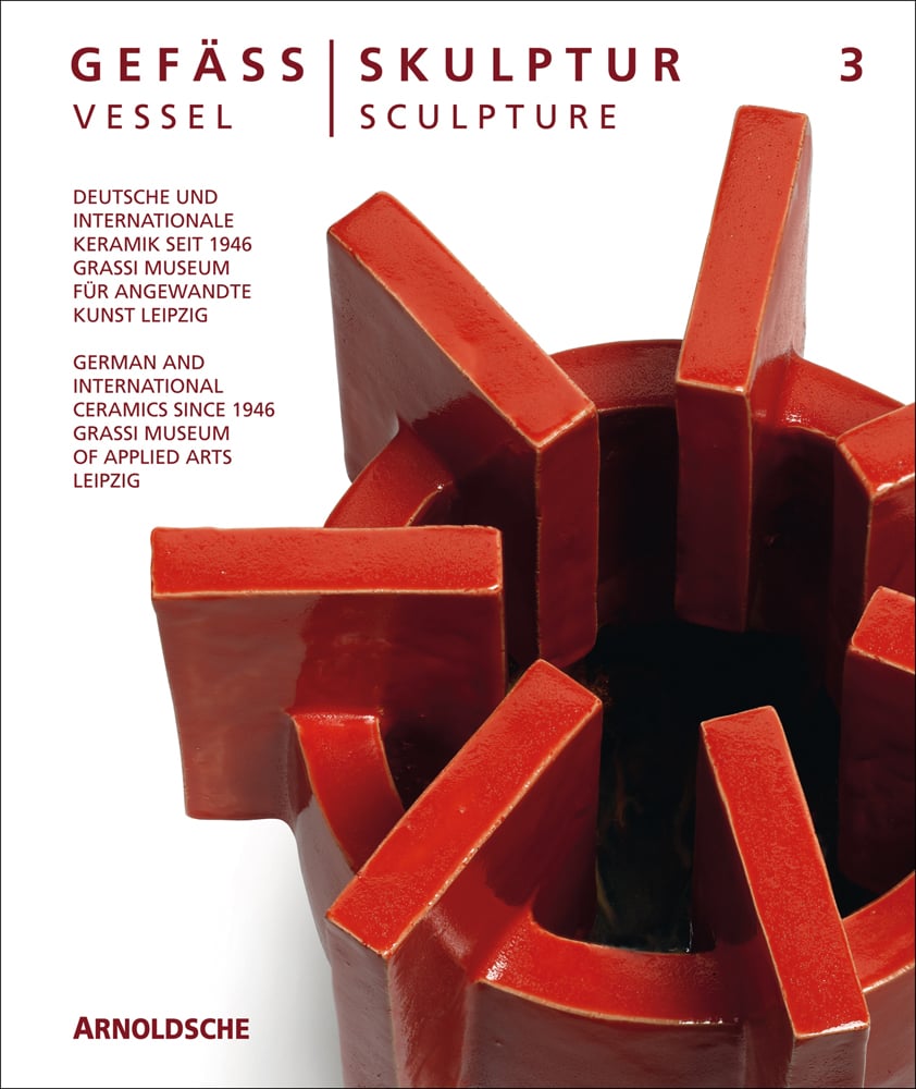 Glazed red ceramic wheel shape, on white cover, Vessel Sculpture 3 in dark red font to top