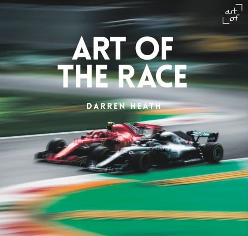 Motion blur shot of Lewis Hamilton in Mercedes F1 car racing alongside red Ferrari, ART OF THE RACE DARREN HEATH in white font above.