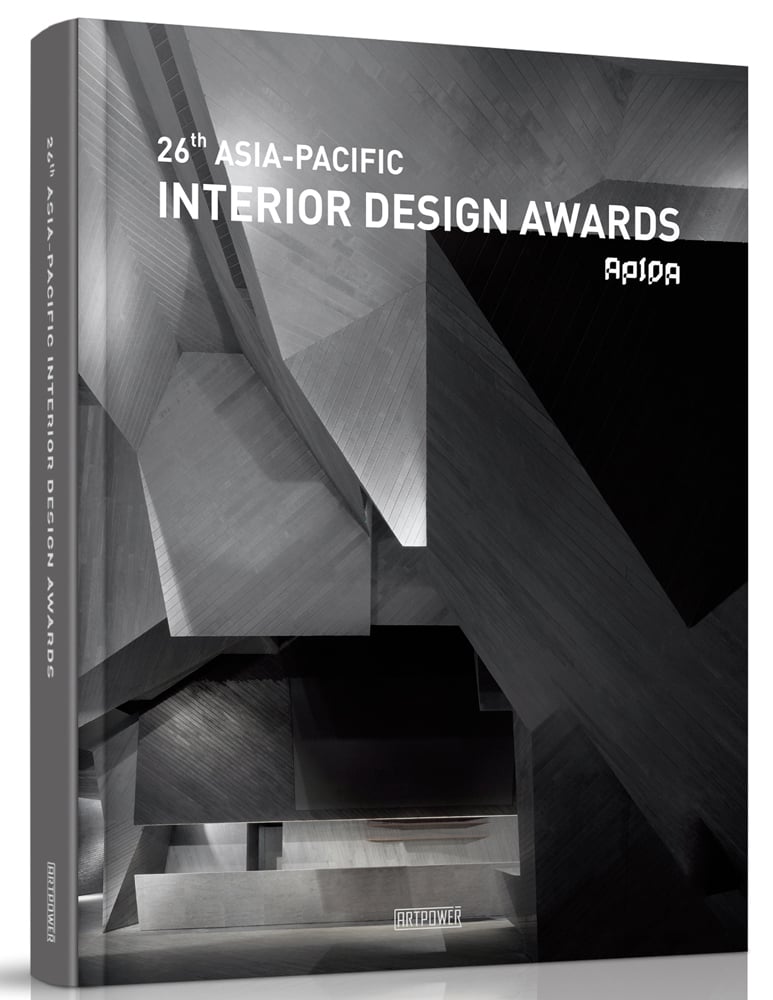 Illuminated grey brutal style interior, 26TH ASIA-PACIFIC INTERIOR DESIGN AWARDS in white font above.
