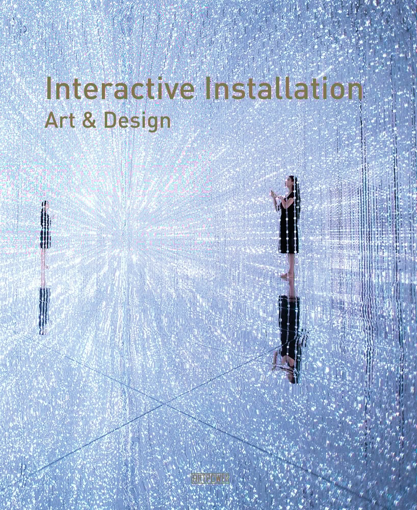 Book cover of Interactive Installation Art & Design, with two human figures standing within a crystallised vortex. Published by Artpower International.