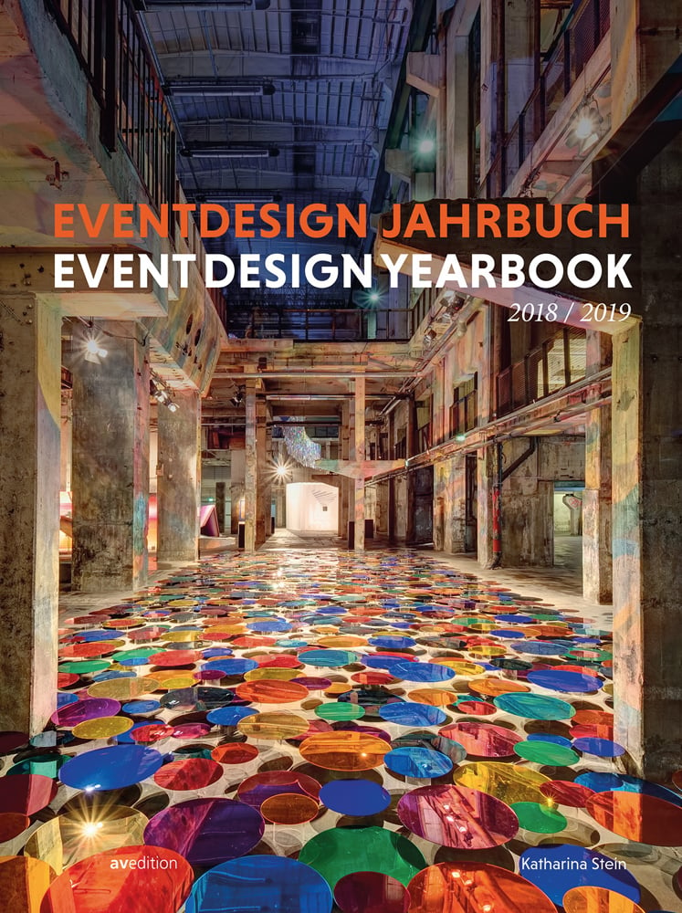 Multicoloured dotted floor, colour reflected onto ceiling structure, on cover of 'Event Design Yearbook 2018 / 2019', by Avedition Gmbh.