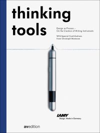 Lamy Pico Pearl Chrome Ballpoint Pen, to center of white cover of 'Thinking Tools, Design as Process - On the Creation of Writing Utensils', by Avedition Gmbh.
