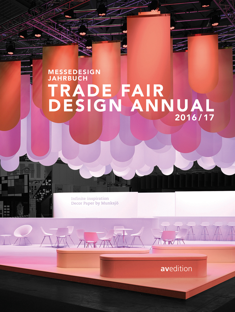 Interior design exhibition with orange and pink sheets of fabric hanging above chairs, on cover of 'Trade Fair Design Annual 2016/2017', by Avedition Gmbh.
