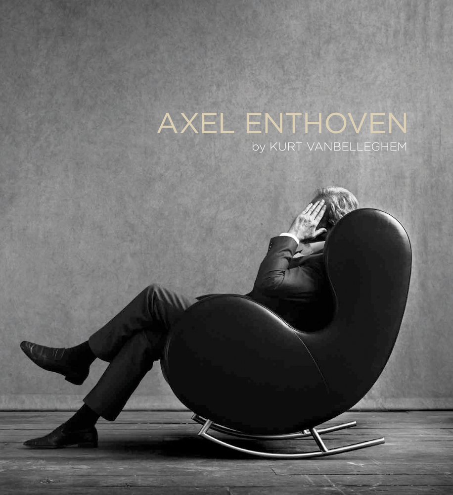 Axel Enthoven sitting in curved chair, hand covering face with Axel Enthoven in beige font above
