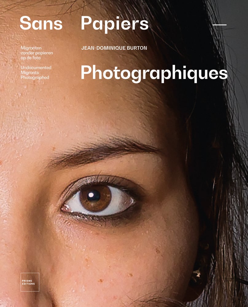 Close up of top left corner of face, Jean-Dominique Burton Photographiques in white font to top