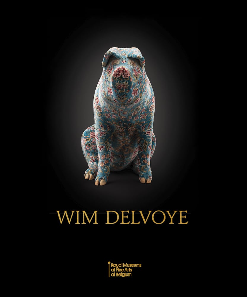 Large sculpture of lone pig in a blue and pink floral pattern, on black cover, WIM DELVOYE in gold font below.