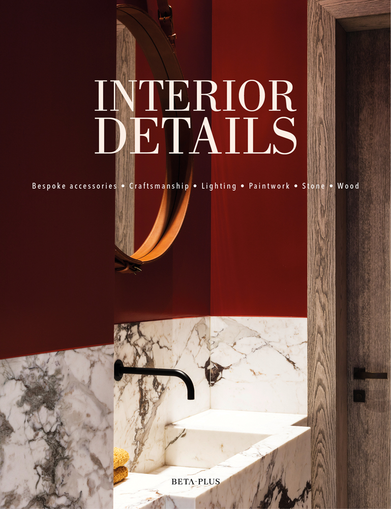 White and grey marbled sink, dark red walls, round mirror, Interior Details in white font above